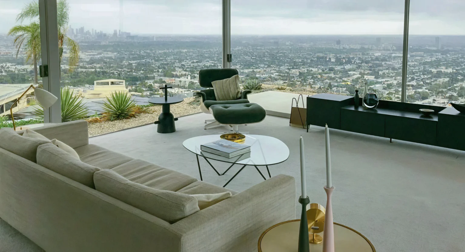 Staged living room with lounge chair and city view